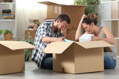 frustrated man and woman with a packing box