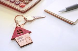 Selling a short lease property. House keys, calculator and note pad.