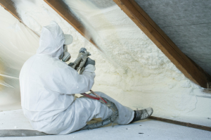 man installing spray foam insulation
